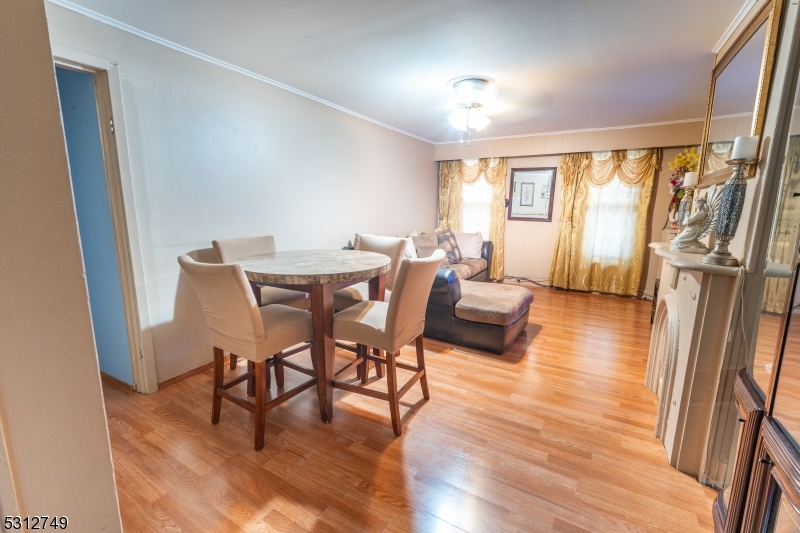 124 Stone Street, Unit 2 Newark, NJ 07104 - Photo 8 of 27 a view of a dining room with furniture and wooden floor