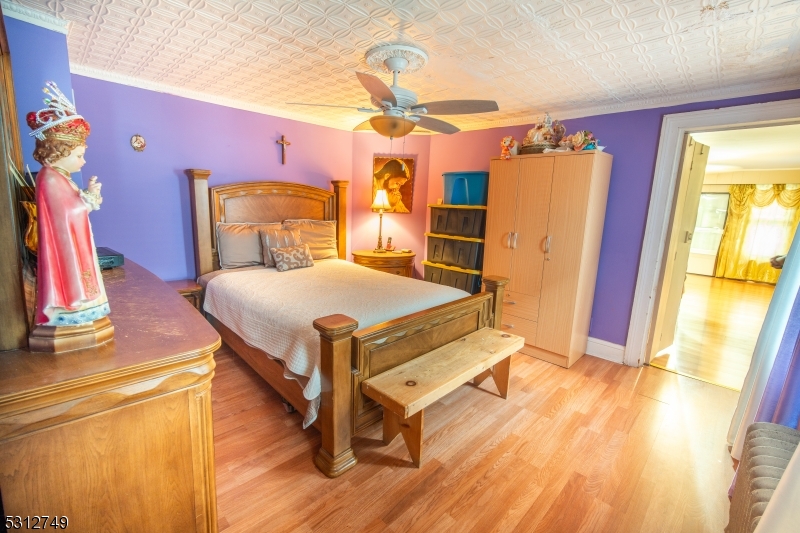 124 Stone Street, Unit 2 Newark, NJ 07104 - Photo 10 of 27 a bedroom with a bed and wooden floor