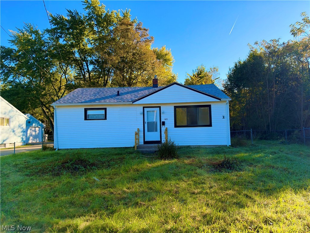 693 Liberty Road Youngstown, OH 44505 - Photo 1 of 14 White siding exterior with dark trim windows, front entry door with side light, and a sloped roofline