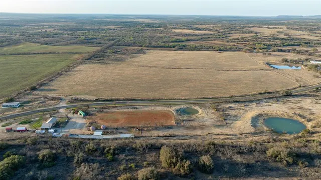 an aerial view of residential houses with outdoor space and river