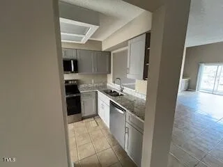 a large kitchen with stainless steel appliances granite countertop a stove and a sink