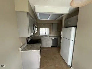 a kitchen with a refrigerator and a sink