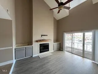 a view of an empty room with a fireplace and a window