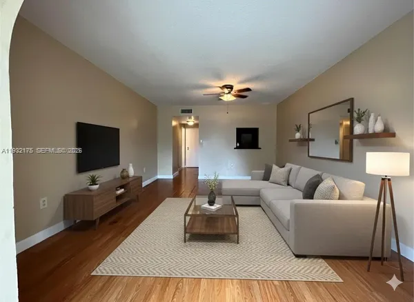 a living room with furniture and a flat screen tv