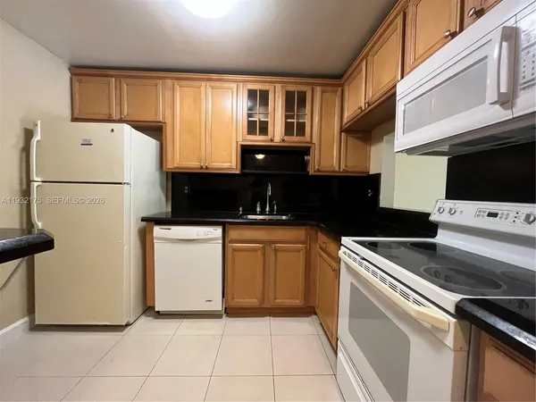 a kitchen with a refrigerator and a stove
