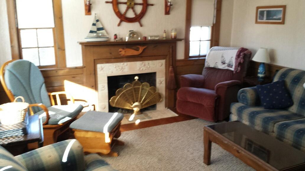 70 Beaten Road Dennis Port, MA 02639 - Photo 2 of 14 a living room with furniture and a fireplace
