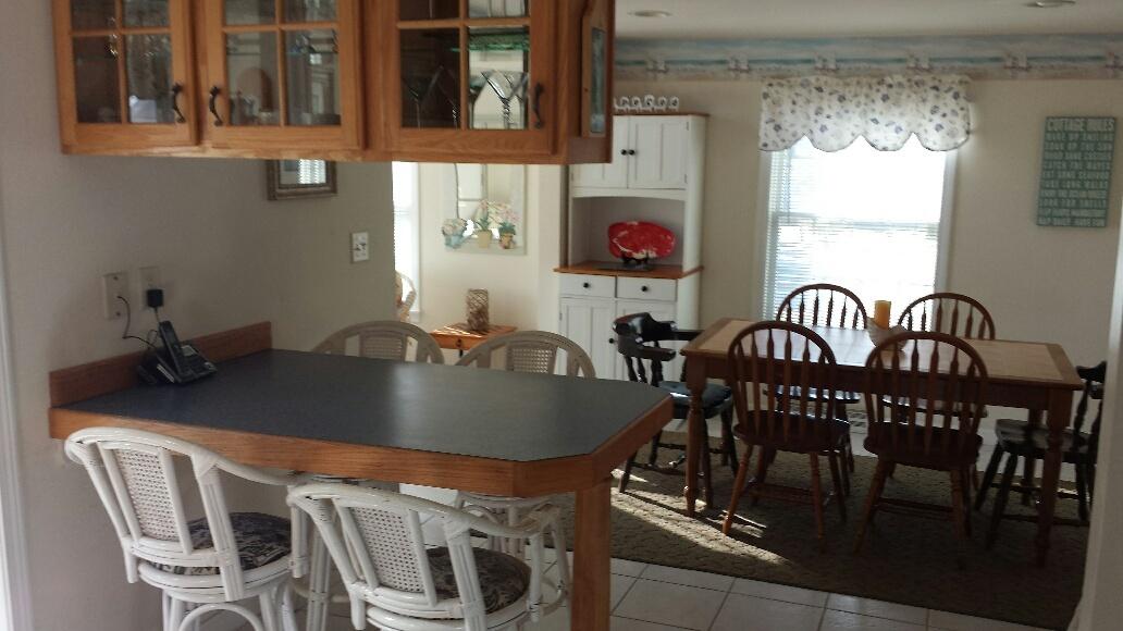70 Beaten Road Dennis Port, MA 02639 - Photo 5 of 14 a table with chairs and a dining table with wooden floor