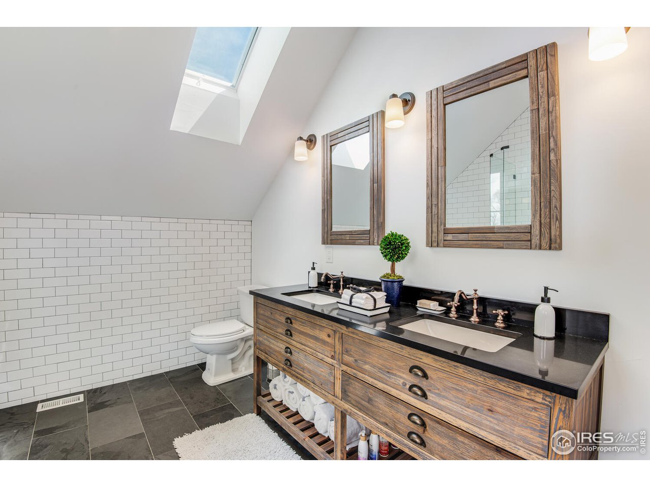 6003 Indian Road Boulder, CO 80301 - Photo 22 of 40 a bathroom with a toilet a sink and mirror