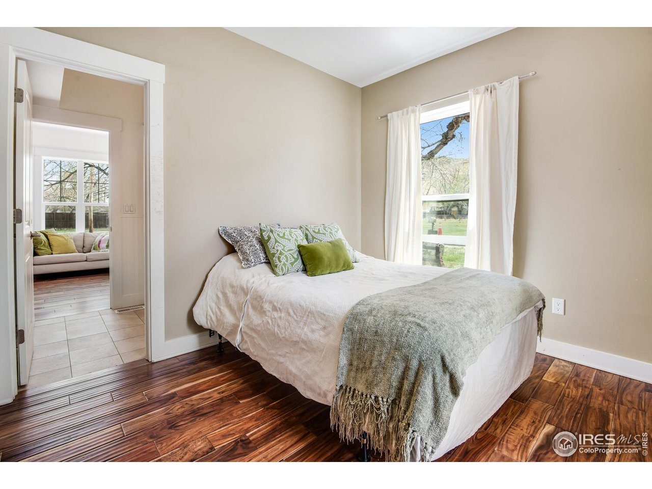 6003 Indian Road Boulder, CO 80301 - Photo 27 of 40 a bedroom with a bed and wooden floor
