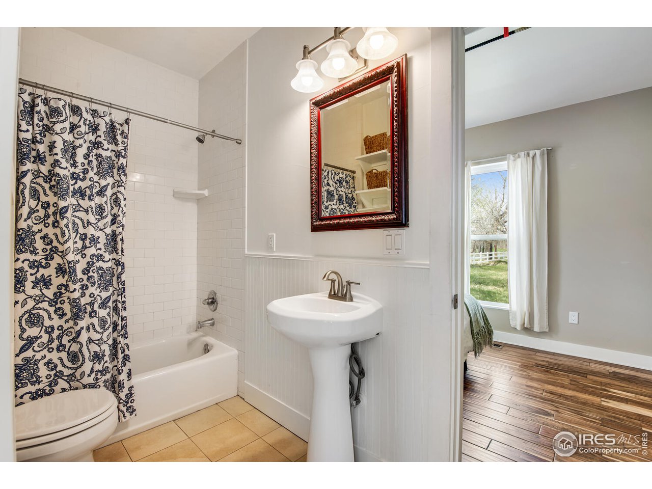 6003 Indian Road Boulder, CO 80301 - Photo 29 of 40 a bathroom with a sink a mirror and a shower