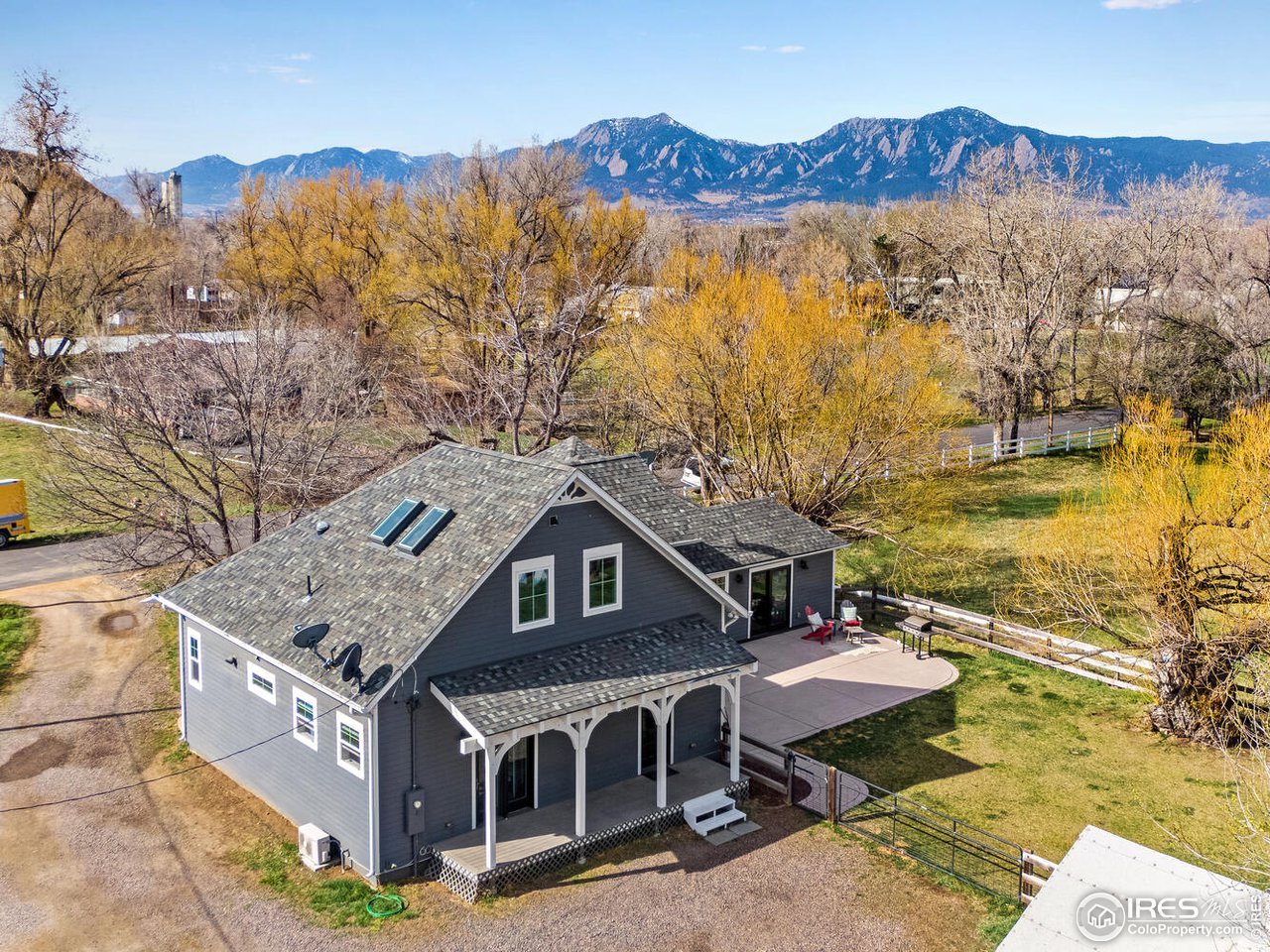 6003 Indian Road Boulder, CO 80301 - Photo 38 of 40 an aerial view of a house with a yard and mountain view in back