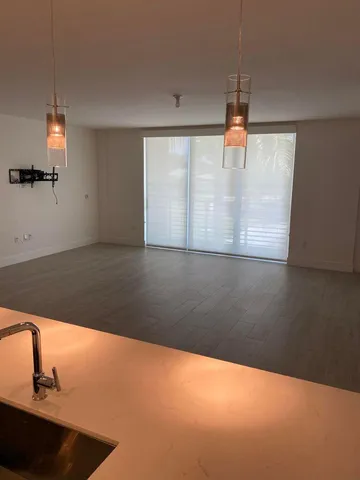 a kitchen with stainless steel appliances a sink and a refrigerator