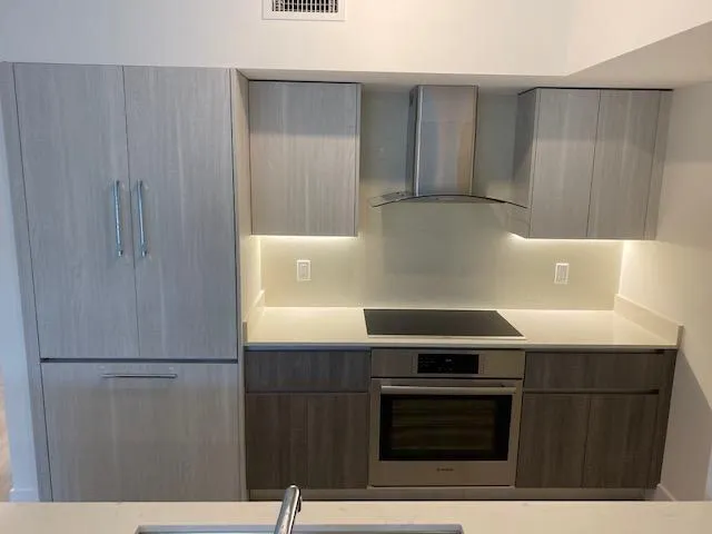 a kitchen with a sink and a refrigerator