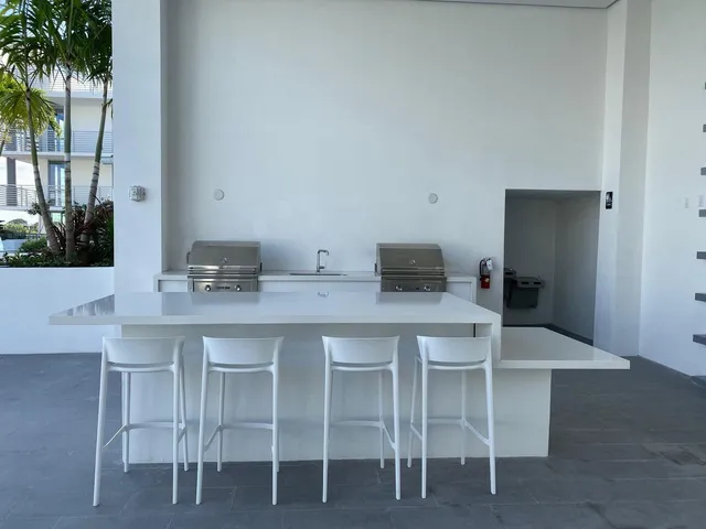 a white kitchen with a table and chairs in it