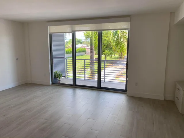a view of a room with wooden floor and doors