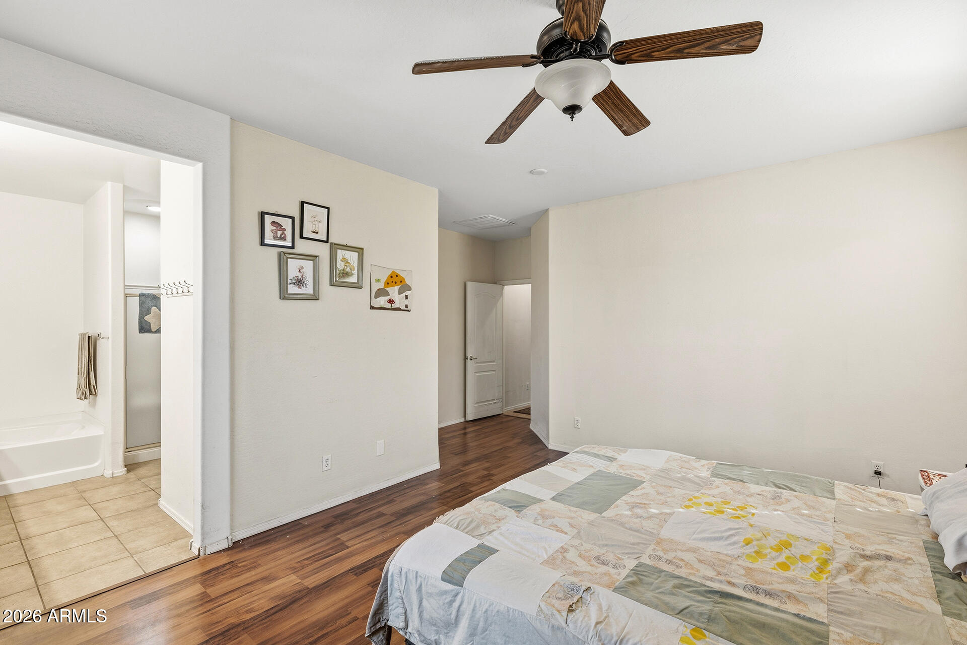 6718 West Darrel Road Laveen, AZ 85339 - Photo 12 of 49 a bedroom with a bed and a chandelier