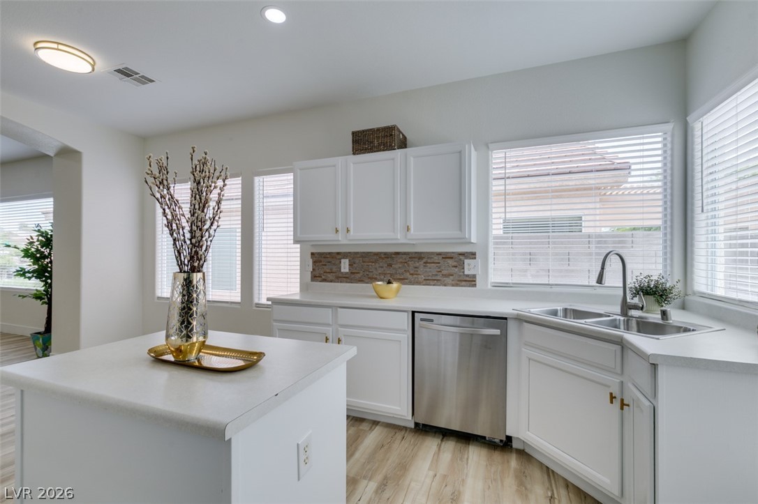 10959 Pumpkin Ridge Avenue Las Vegas, NV 89135 - Photo 17 of 51 A well-lit kitchen with sleek countertops and ample cabinetry provides an inviting culinary space.