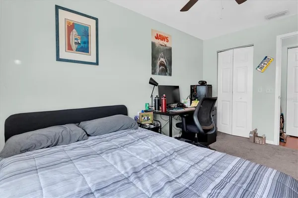 a bedroom with a bed and a table in it
