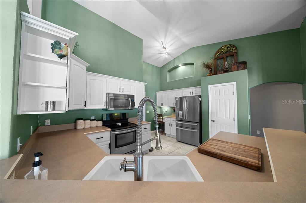 10080 Southeast 69th Terrace Belleview, FL 34420 - Photo 14 of 51 a living room with stainless steel appliances furniture and a kitchen view