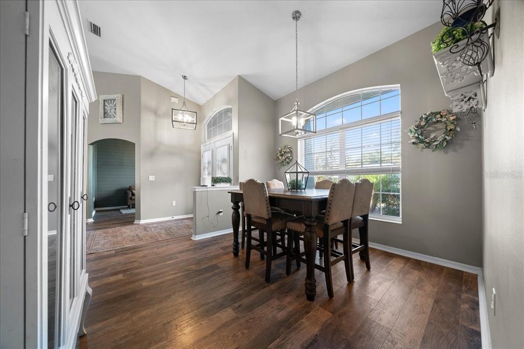 10080 Southeast 69th Terrace Belleview, FL 34420 - Photo 18 of 51 a view of a dining room with furniture window and wooden floor