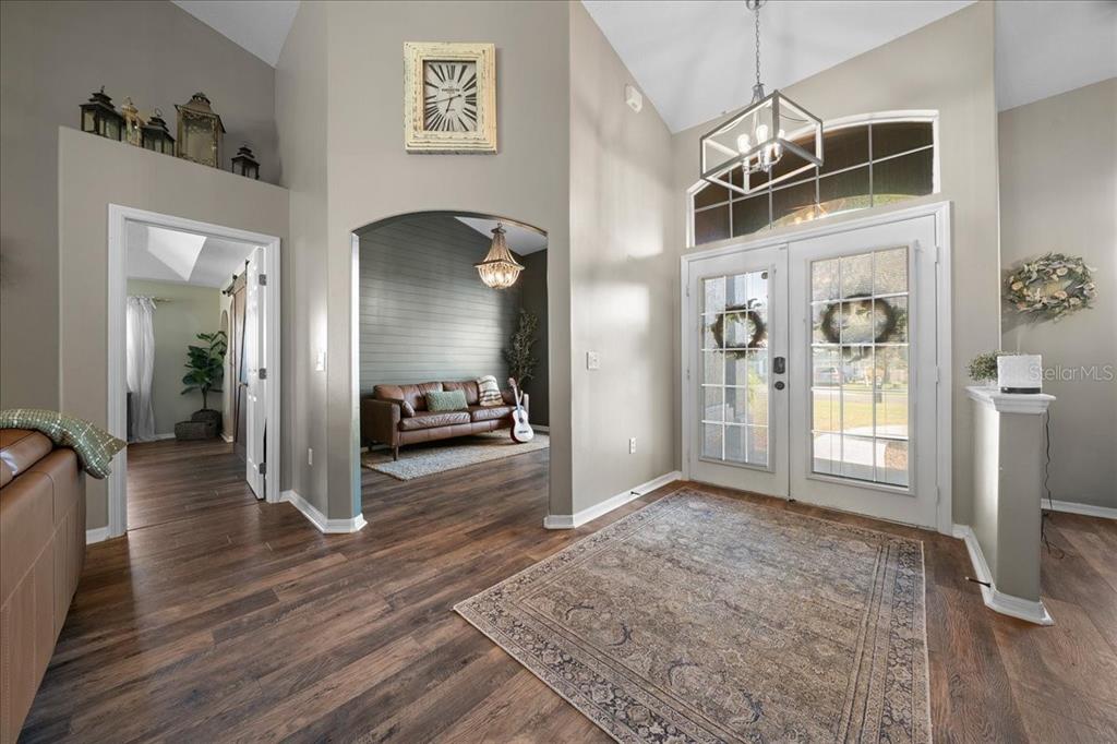 10080 Southeast 69th Terrace Belleview, FL 34420 - Photo 19 of 51 a view of a hallway view with living room and wooden floor