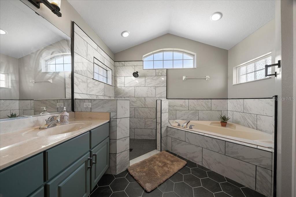10080 Southeast 69th Terrace Belleview, FL 34420 - Photo 26 of 51 a bathroom with a sink and a mirror