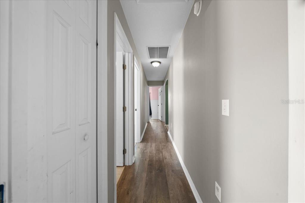 10080 Southeast 69th Terrace Belleview, FL 34420 - Photo 29 of 51 a view of a hallway with wooden floor