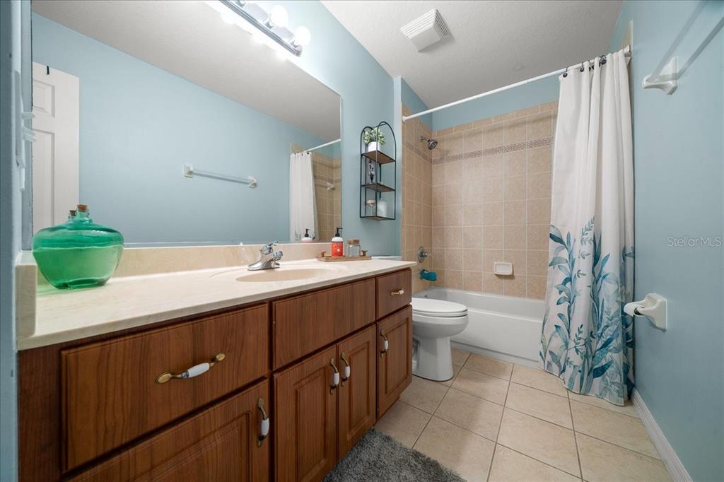 10080 Southeast 69th Terrace Belleview, FL 34420 - Photo 30 of 51 a bathroom with a double vanity sink toilet and shower
