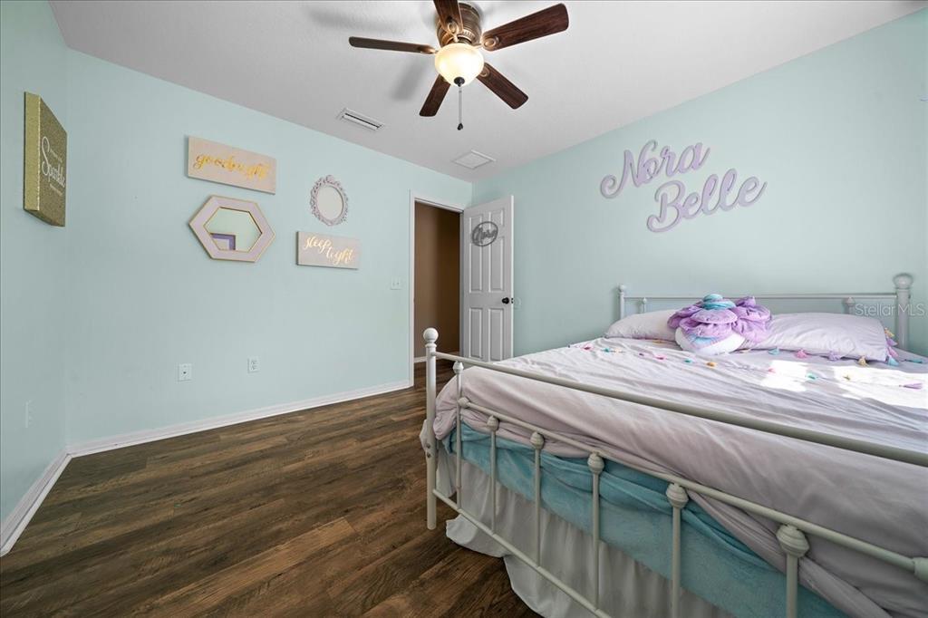 10080 Southeast 69th Terrace Belleview, FL 34420 - Photo 32 of 51 a bedroom with a bed and a chandelier