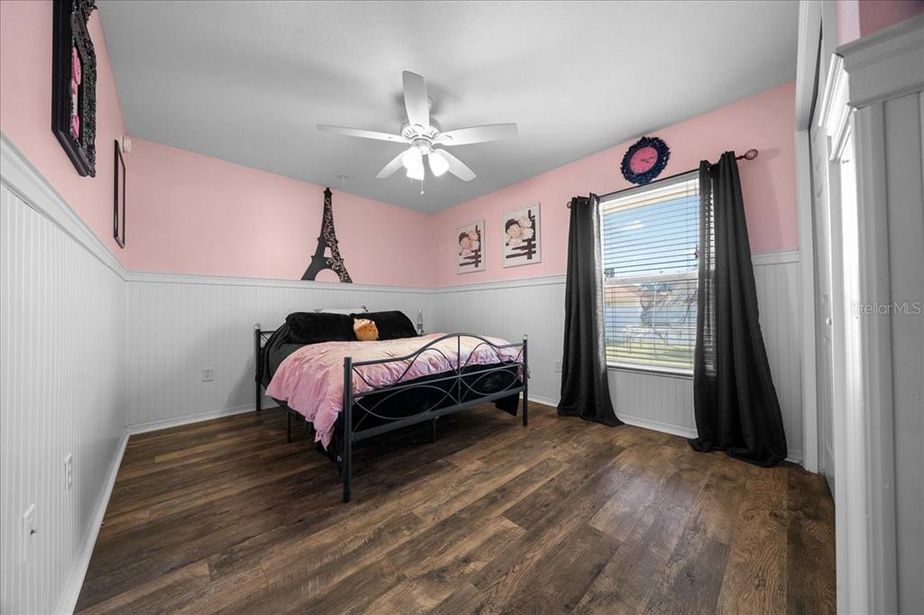 10080 Southeast 69th Terrace Belleview, FL 34420 - Photo 34 of 51 a bed room with a bed and a chandelier