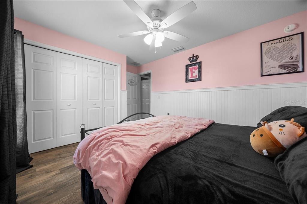 10080 Southeast 69th Terrace Belleview, FL 34420 - Photo 35 of 51 a bedroom with a bed and a chandelier