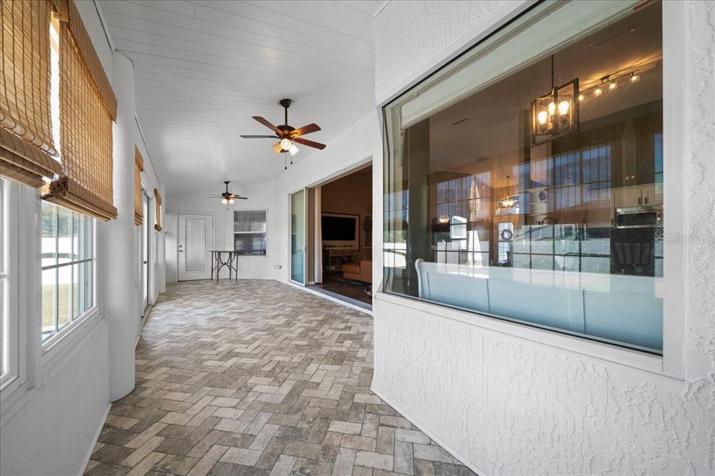 10080 Southeast 69th Terrace Belleview, FL 34420 - Photo 39 of 51 a very nice looking room with a large window and chandelier
