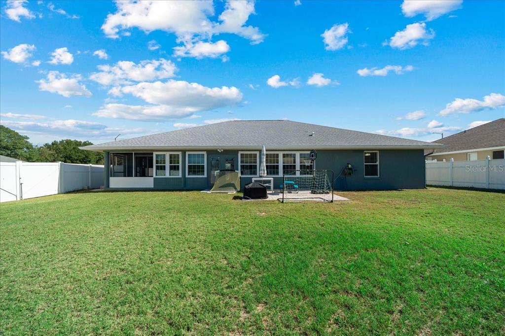 10080 Southeast 69th Terrace Belleview, FL 34420 - Photo 40 of 51 a front view of a house with a garden