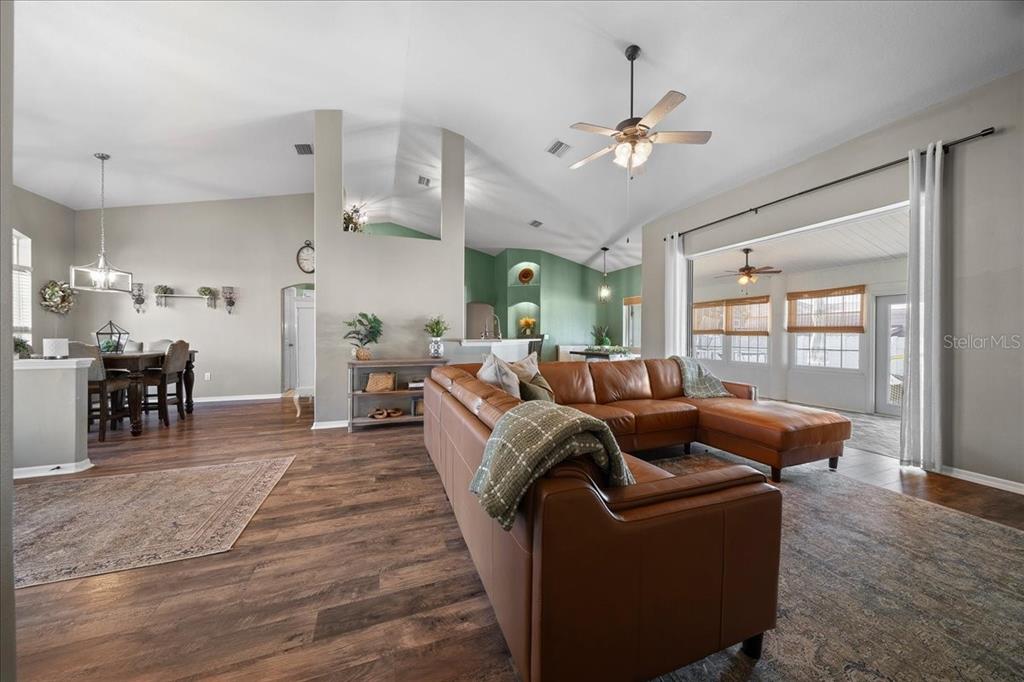 10080 Southeast 69th Terrace Belleview, FL 34420 - Photo 8 of 51 a living room with furniture and wooden floor