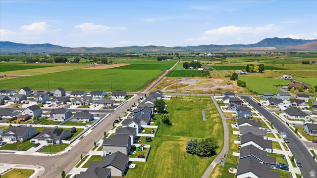 730 West 500 North Smithfield, UT 84335 - Photo 42 of 46 Expansive aerial showcasing a residential neighborhood with varied single-story and two-story homes featuring dark shingle roofs and light-colored siding