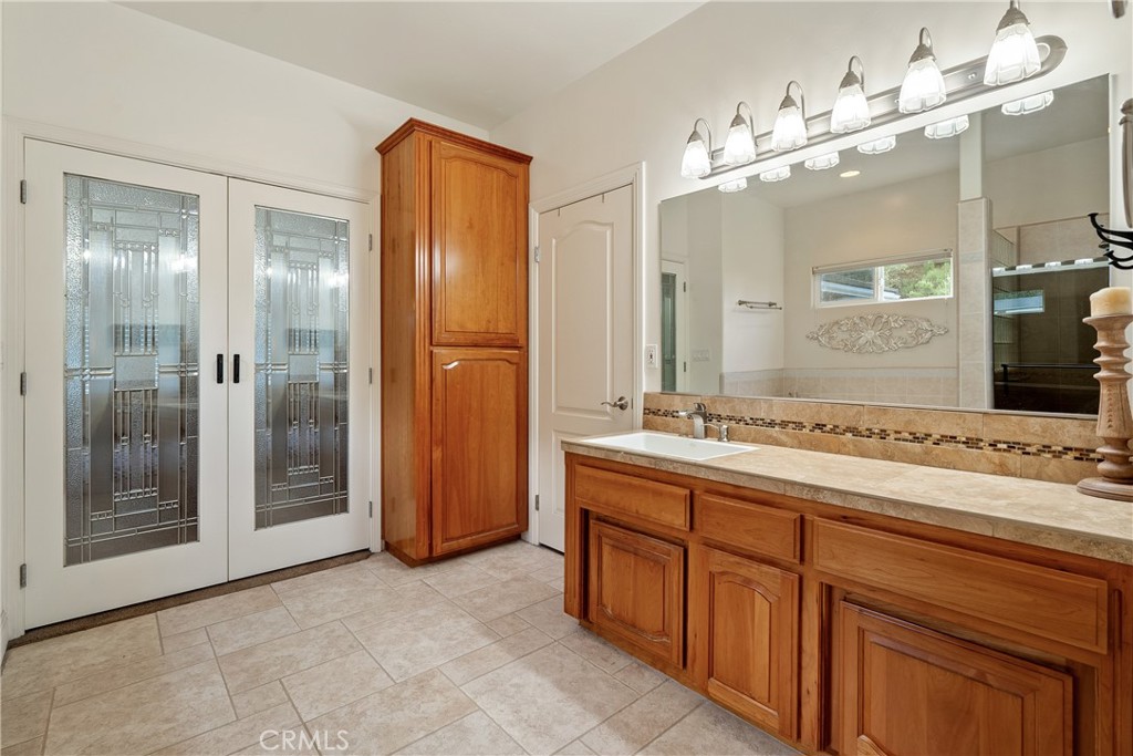 10844 Vista Atascadero Ca Atascadero, CA 93422 - Photo 33 of 74 a bathroom with a granite countertop sink a large mirror and a shower