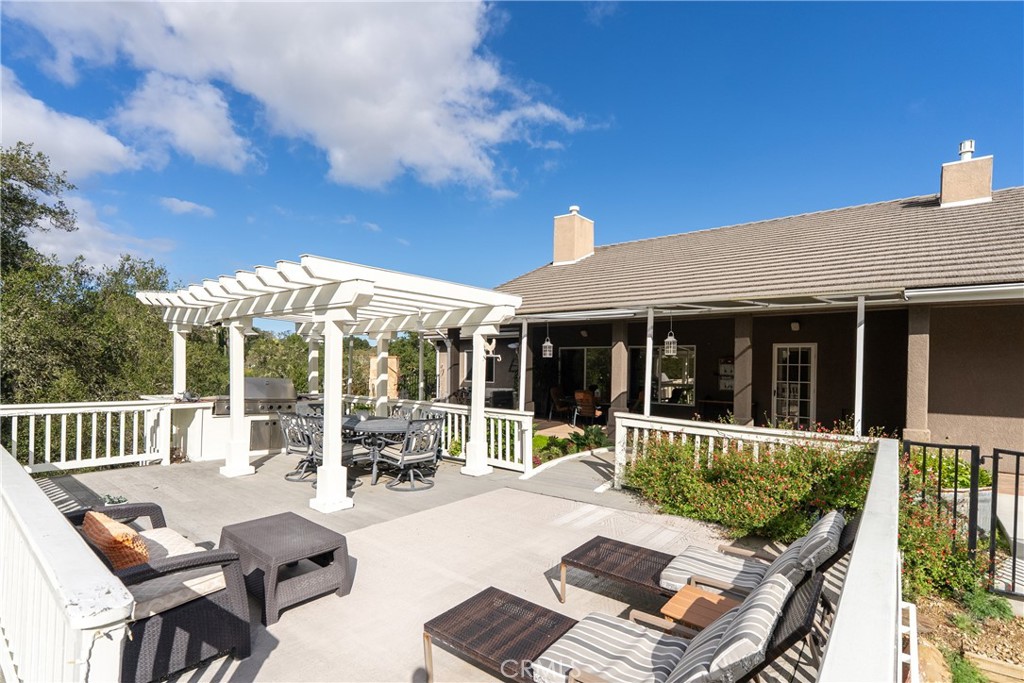 10844 Vista Atascadero Ca Atascadero, CA 93422 - Photo 59 of 74 a view of a patio with a table chairs and a floor to ceiling window