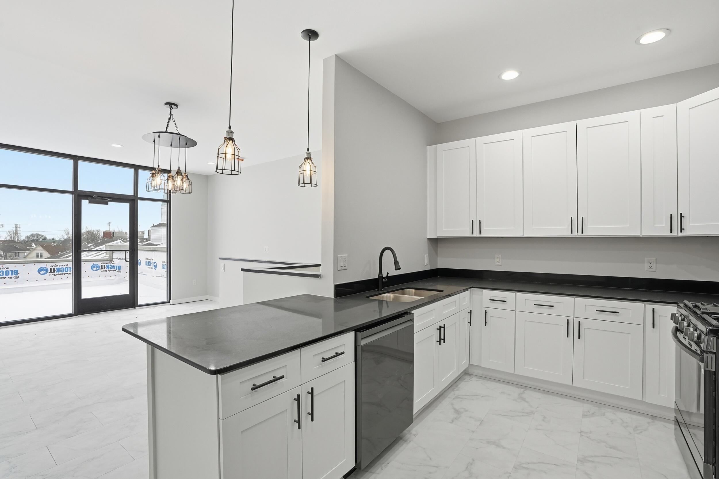 1540 119th Street, Unit 201 Whiting, IN 46394 - Photo 4 of 17 a kitchen with granite countertop white cabinets and white appliances