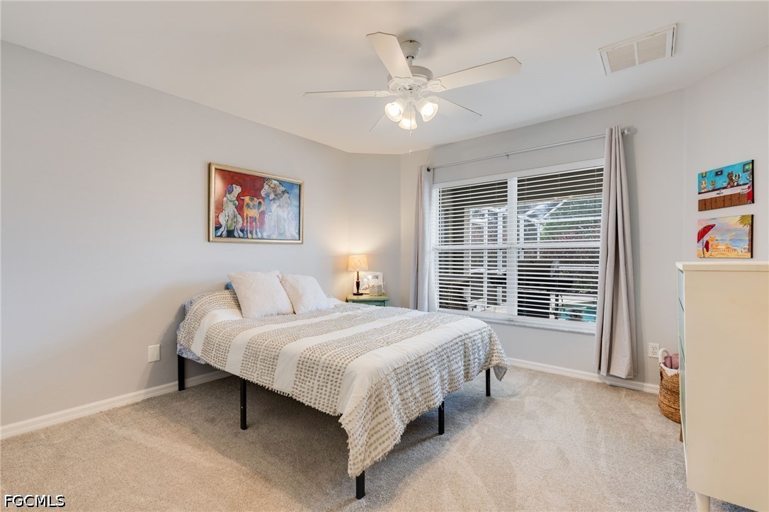 3801 28th Street Southwest Lehigh Acres, FL 33976 - Photo 14 of 37 a bedroom with a bed painting on wall and a large window