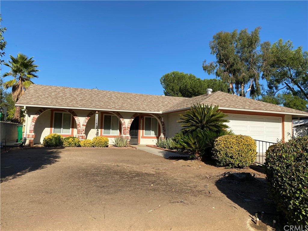 34278 Olive Grove Road Wildomar, CA 92595 - Photo 1 of 1 a front view of a house with a yard and garage