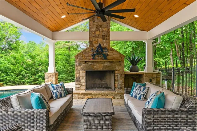 a living room with furniture a flat screen tv and a fireplace