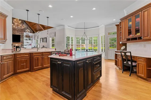 a front view of a house with a yard and potted plants