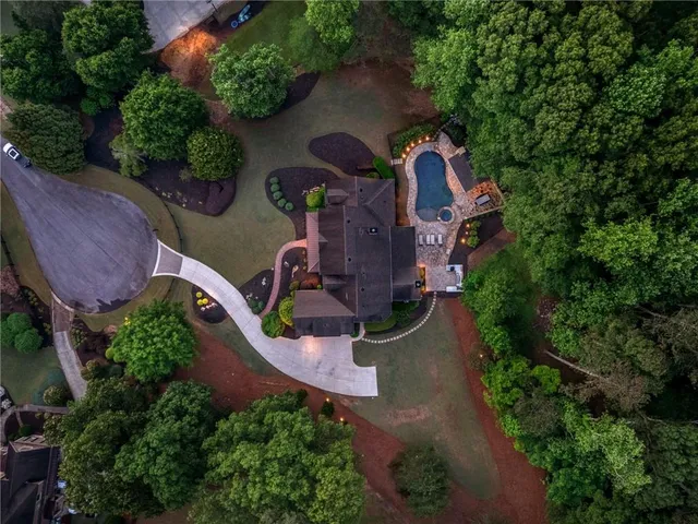 a living room with furniture large window and wooden floor