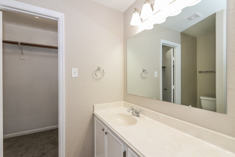13214 Montclair Point Court Houston, TX 77047 - Photo 11 of 17 a bathroom with a sink vanity granite and a mirror