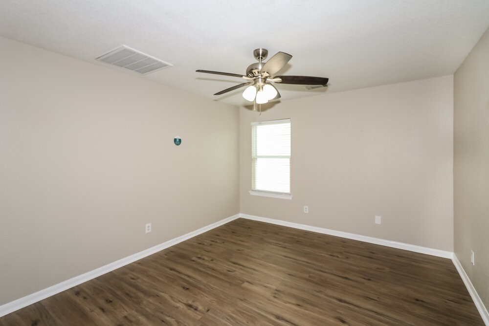 13214 Montclair Point Court Houston, TX 77047 - Photo 13 of 17 a view of a room with wooden floor and a ceiling fan