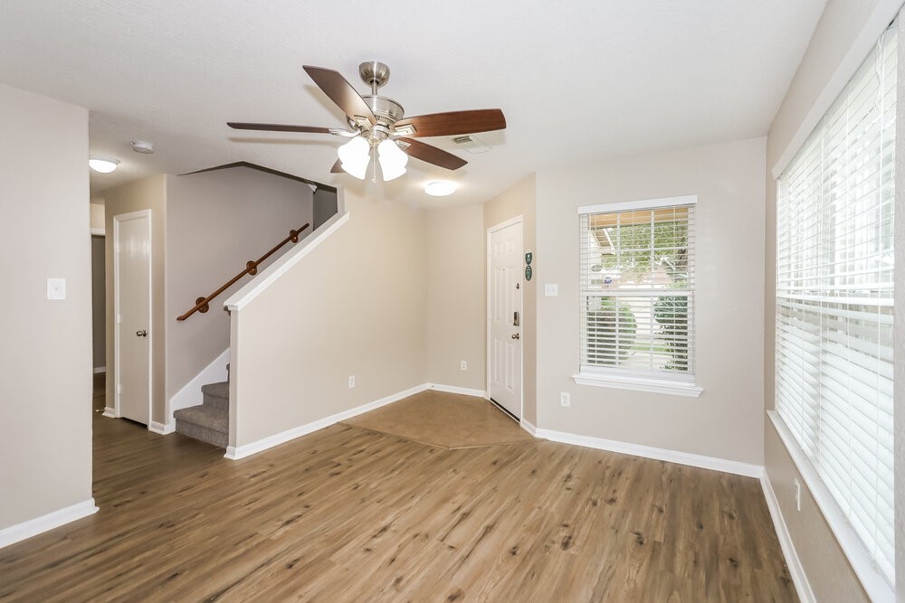 13214 Montclair Point Court Houston, TX 77047 - Photo 5 of 17 a view of an empty room with wooden floor and a window