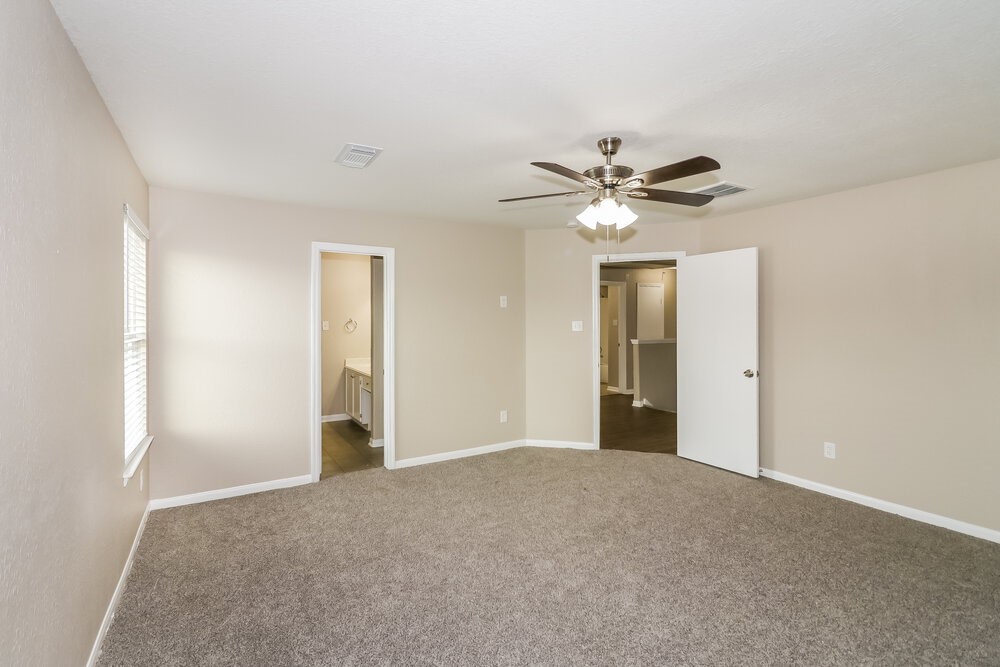 13214 Montclair Point Court Houston, TX 77047 - Photo 10 of 17 a view of an empty room with a ceiling fan