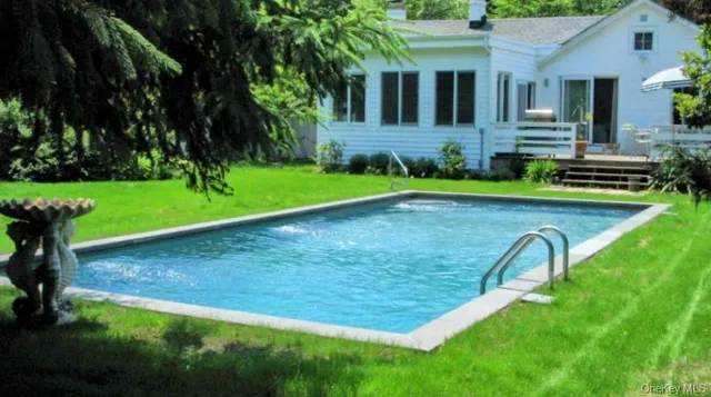 a view of backyard with swimming pool