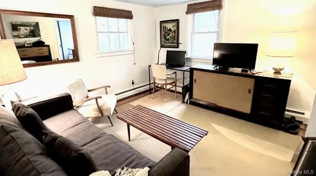 a view of a livingroom with workspace and a couch