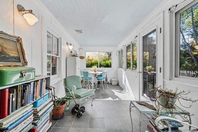 a living room with furniture and a book shelf